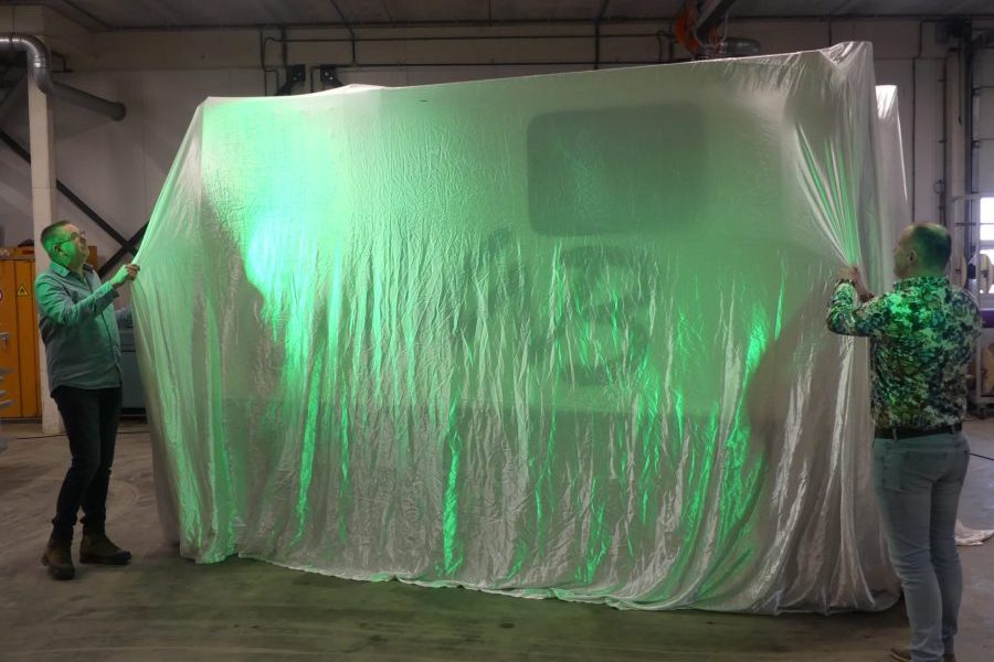 Machine with sheet over it for revealing